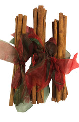 Bundles of cinnamon sticks with red ribbons on a white background
