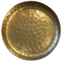 Gold-colored metal plate with a textured surface on a white background